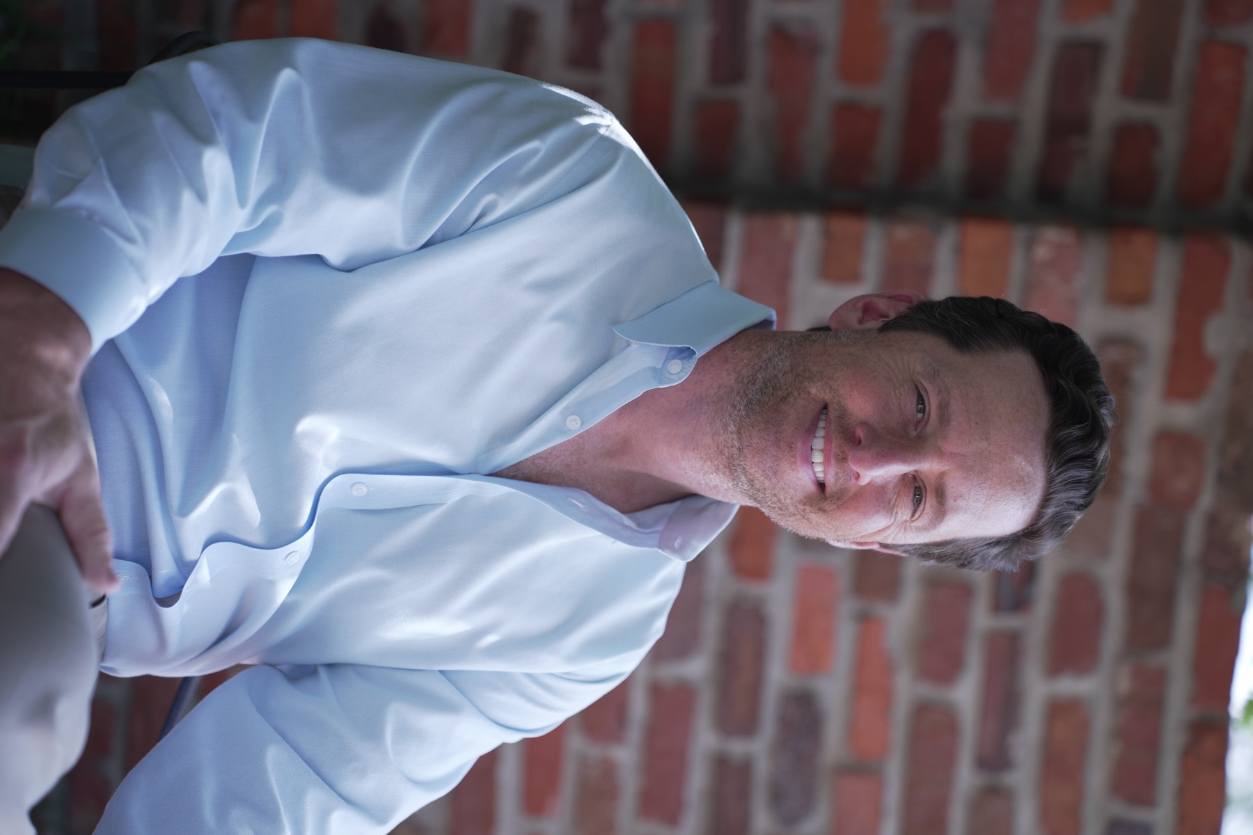 Thomas Dunn smiling in a light blue shirt